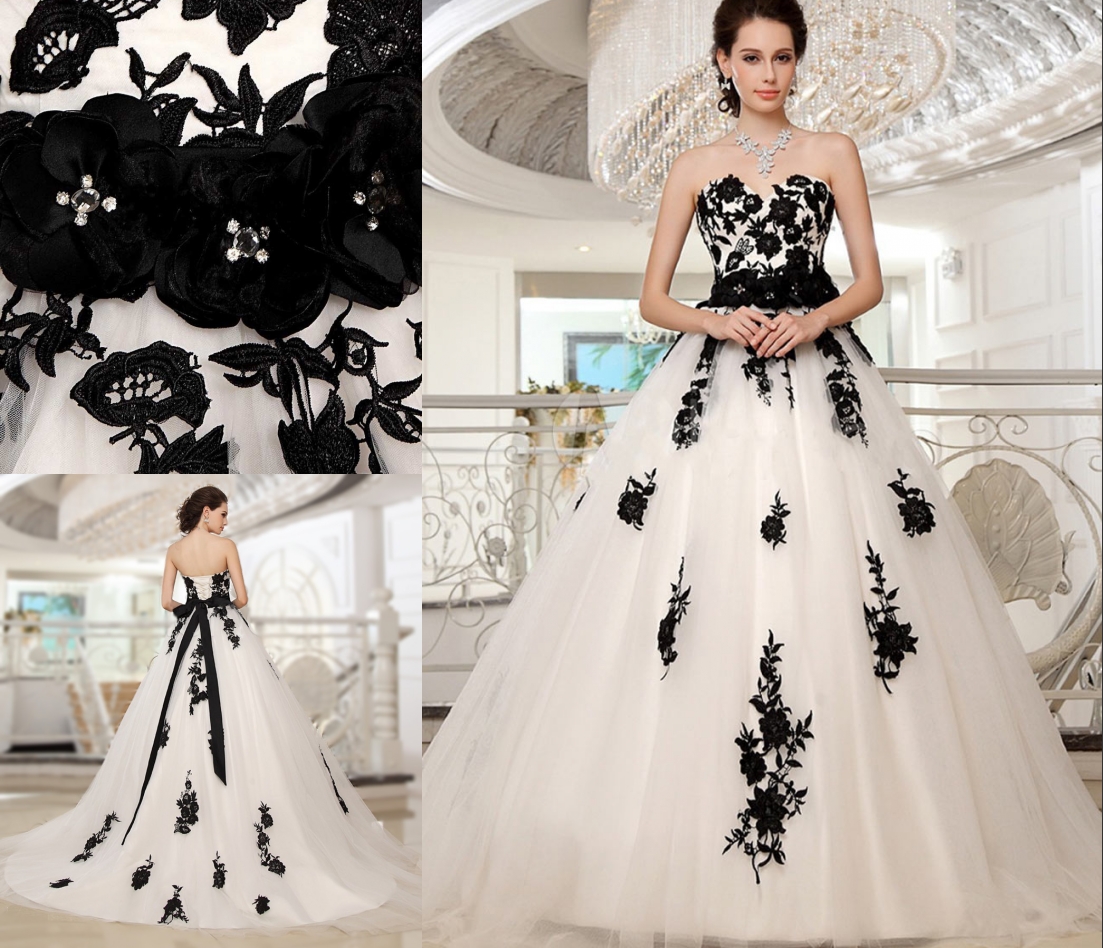 robe de mariée blanche princesse couvert en dentelle appliquée de fleurs noires et ceinturé de fleurs fait-main